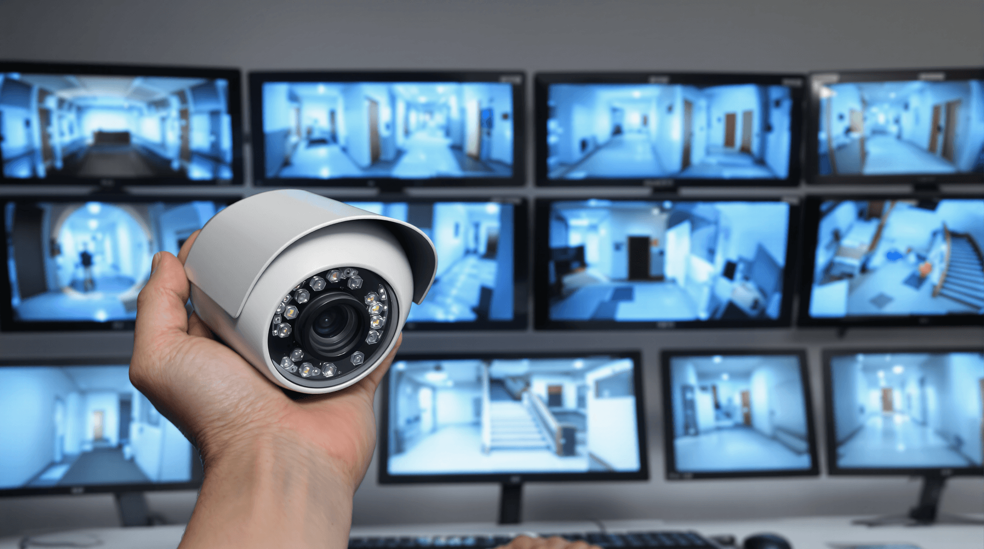 Security camera against a background of monitors with video streams from different rooms.
